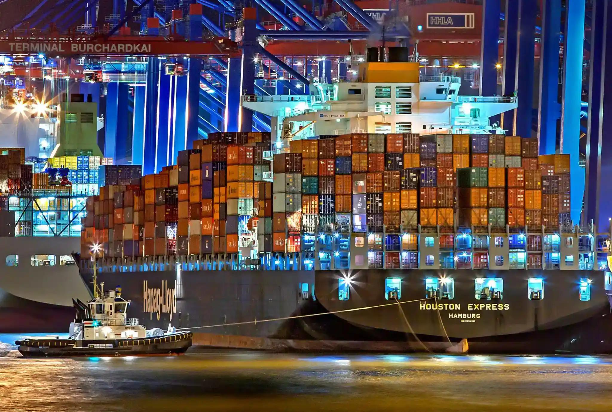 Cargo ship with containers at port at night