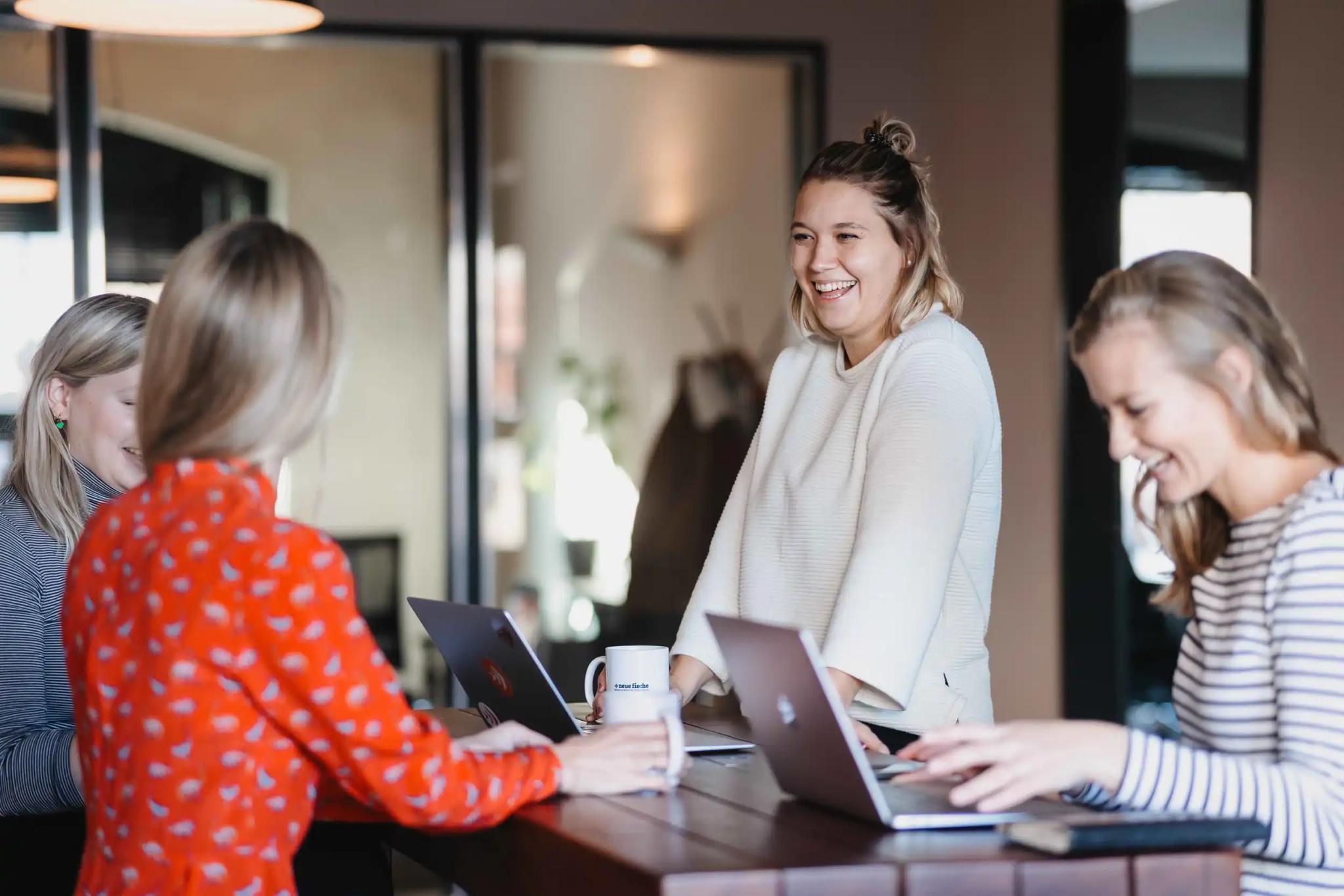 Group of women working together on laptops