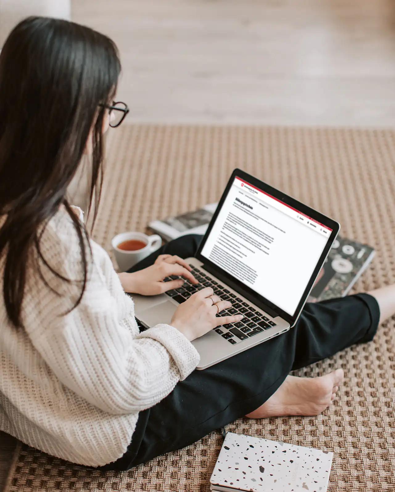 Woman working on laptop at home.