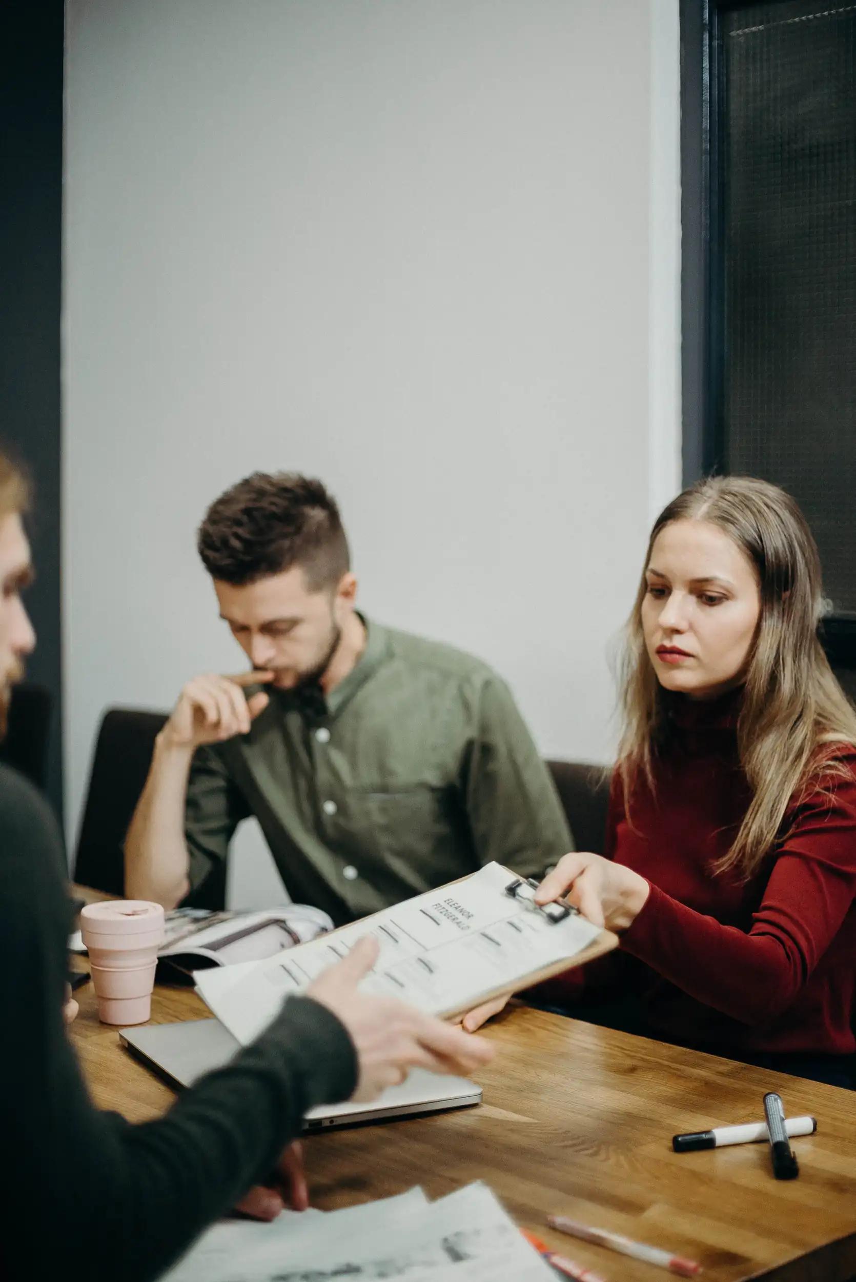 People in a meeting discussing documents.