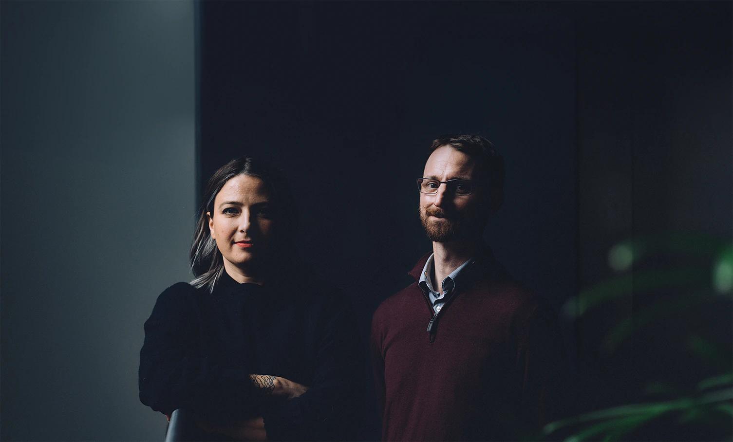 Portrait photo of two people against a dark background