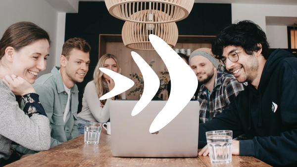 Group of people working together on a laptop